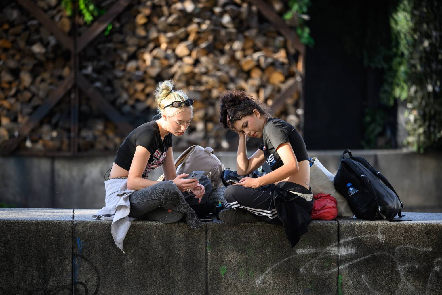 Teens on their phones in a park