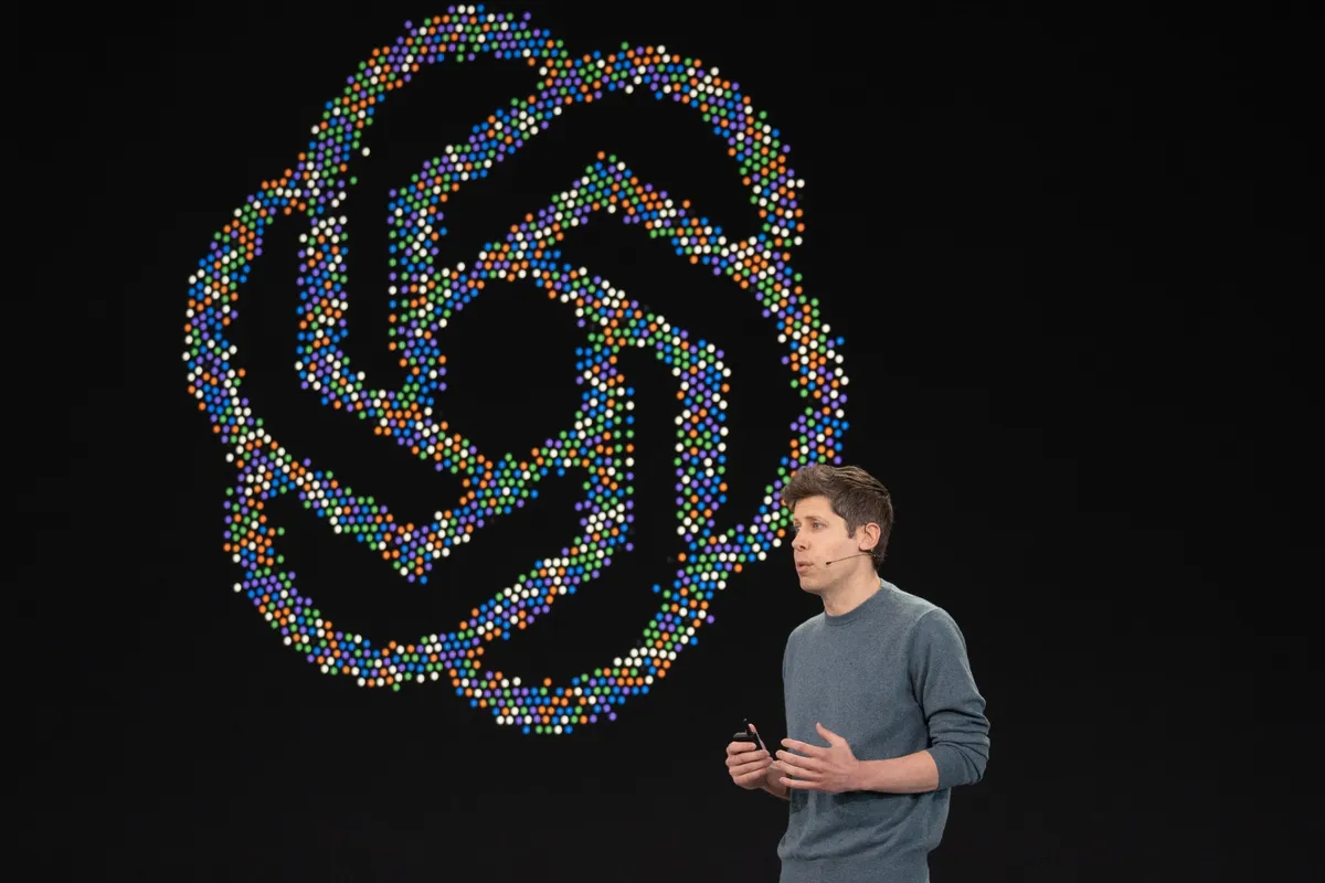 Sam Altman in front of OpenAI logo